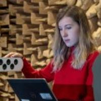 Female undergraduate acoustical engineering student testing equipment