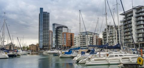 Yachts in Ocean Village Marina, showing skyline on a cloudy day. 