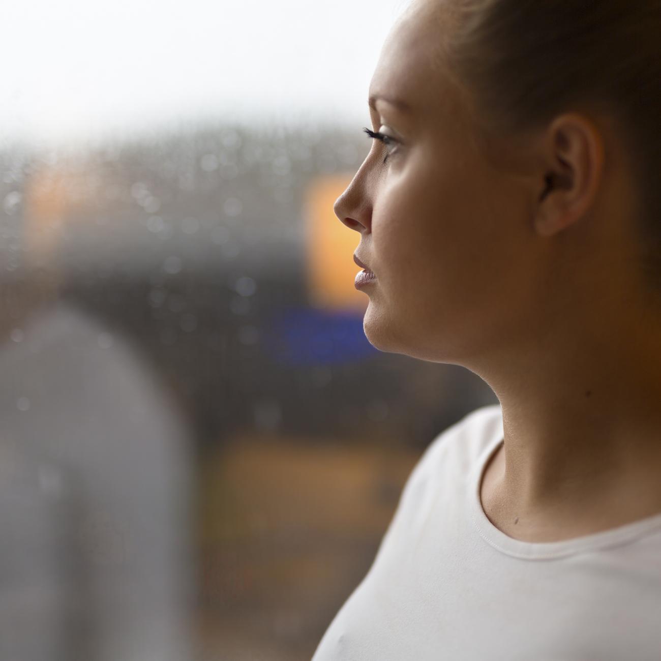 Young women looking out of a window.