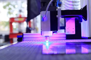 A pulsed fibre laser cutting through metal