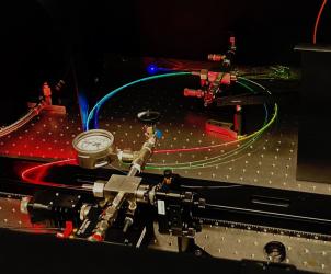 A gas-filled hollow core optical fibre scatters a spectrum of colours. 