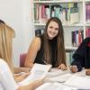 A group of students discuss their work