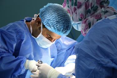 Image of two surgeons performing surgery. 