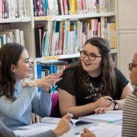 Group of history students in discussion in a library setting