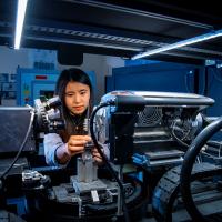 A mechanical engineering student uses a piece of complex machinery