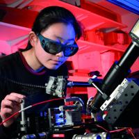 Person in laboratory using laser equipment