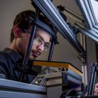 A research student uses equipment in the visual haptic lab