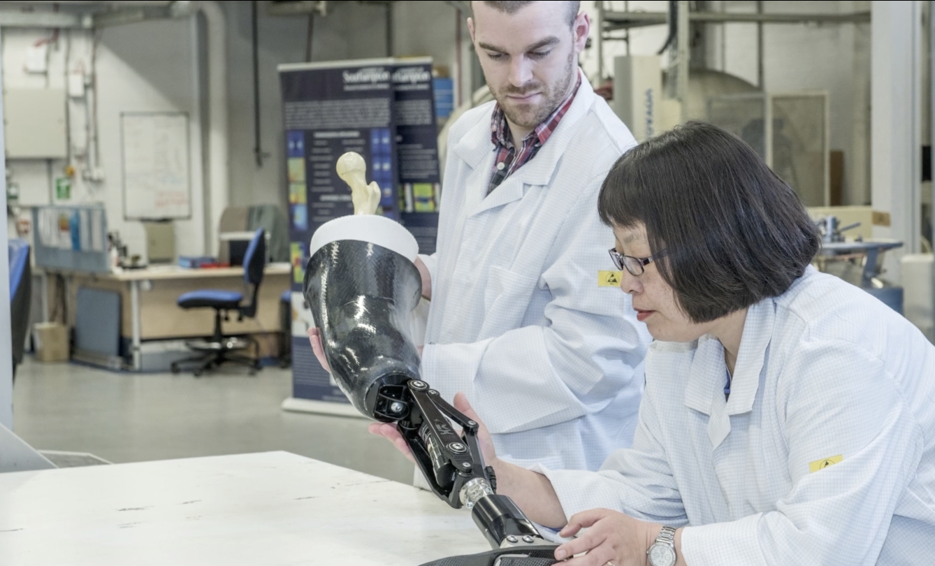 Lab technicians with a prosthetic limb