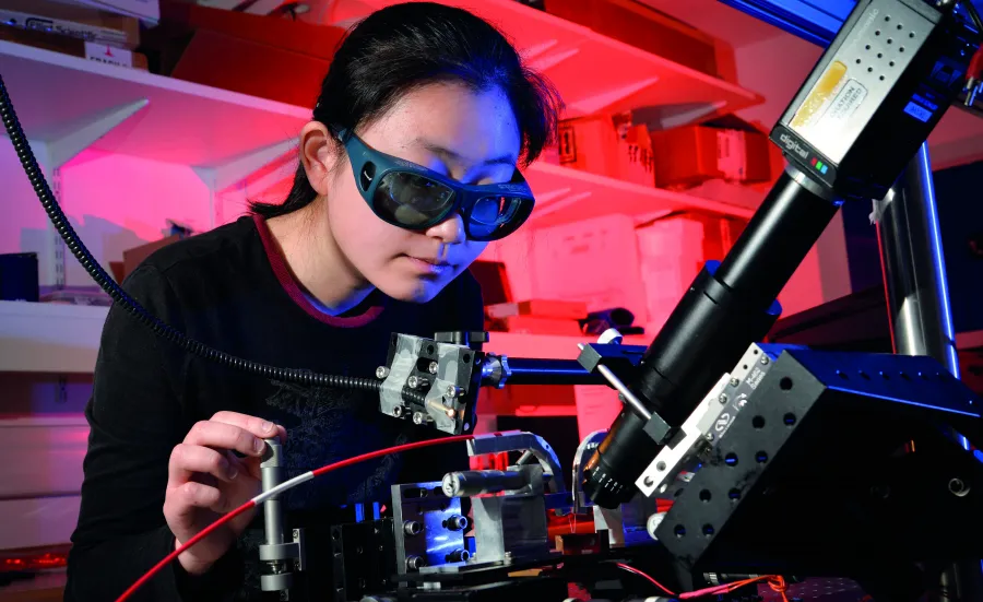 Person in laboratory using laser equipment