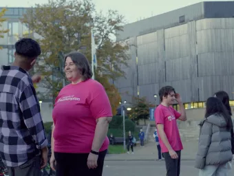 Students being shown around a university campus during a tour.